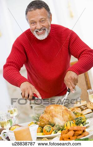 Stock Photo - Man Carving Roast Chicken. Fotosearch