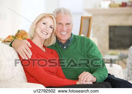 Stock Image - Mature Couple At Christmas. Fotosearch