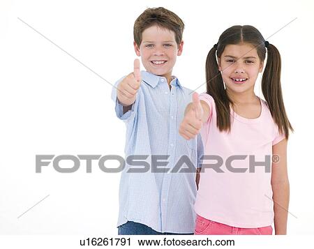 Brother and sister giving thumbs up smiling View Large Photo Image Stock Image - Brother and sister giving thumbs up smiling. Fotosearch