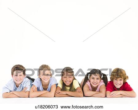 Stock Image - Row of five friends lying down smiling. Fotosearch