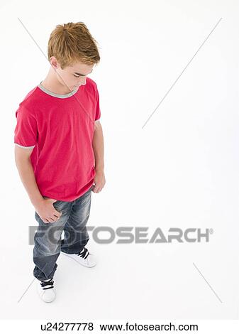 Teenage boy looking down View Large Photo Image Stock Photo - Teenage boy looking down. Fotosearch
