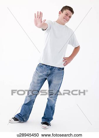 Teenage boy standing with hand up View Large Photo Image Stock Image - Teenage boy standing with hand up. Fotosearch