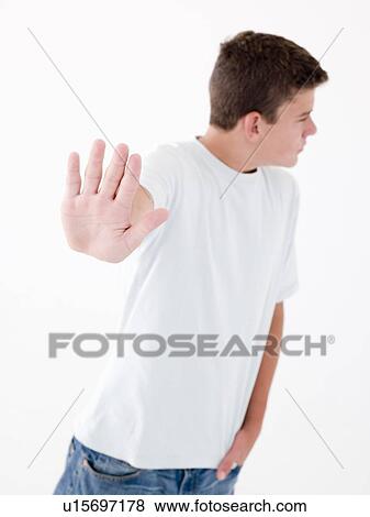 Stock Photo - Teenage boy standing with hand up. Fotosearch