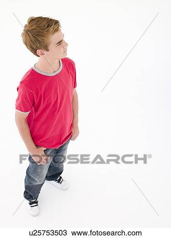 Stock Image - Teenage boy with hands in pockets. Fotosearch
