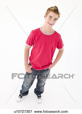 Teenage boy with hands in pockets smiling View Large Photo Image Stock Photo - Teenage boy with hands in pockets smiling. Fotosearch