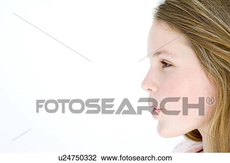 Stock Image - Teenage girl standing with mouth open. Fotosearch