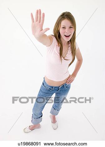 Teenage girl with hand up smiling View Large Photo Image Stock Image - Teenage girl with hand up smiling. Fotosearch