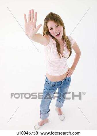Stock Photo - Teenage girl with hand up smiling. Fotosearch