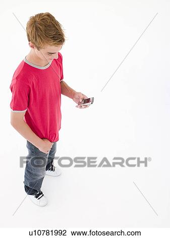 Young boy using cellular phone View Large Photo Image Stock Image - Young boy using cellular phone. Fotosearch