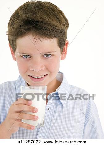 Stock Image - Young boy with glass of milk smiling. Fotosearch