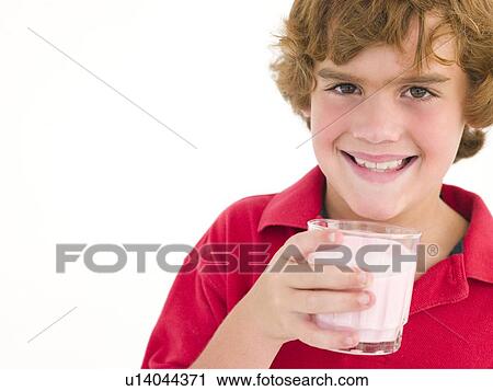 Stock Image - Young boy with glass of milk smiling. Fotosearch