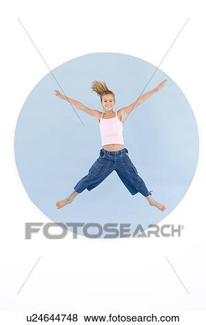 Young girl jumping with arms out smiling View Large Photo Image Stock Photo - Young girl jumping with arms out smiling. Fotosearch