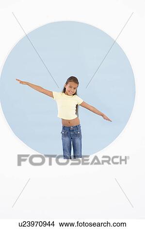Picture - Young girl standing with arms out smiling. Fotosearch