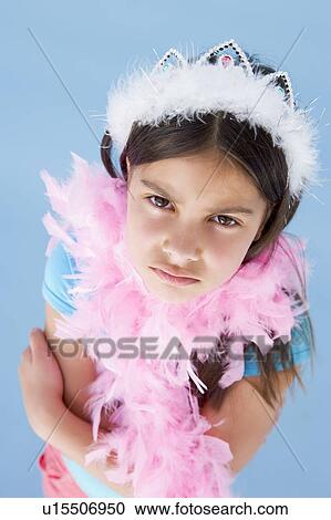 Young girl wearing crown and feather boa frowning View Large Photo Image Stock Image - Young girl wearing crown and feather boa frowning. Fotosearch