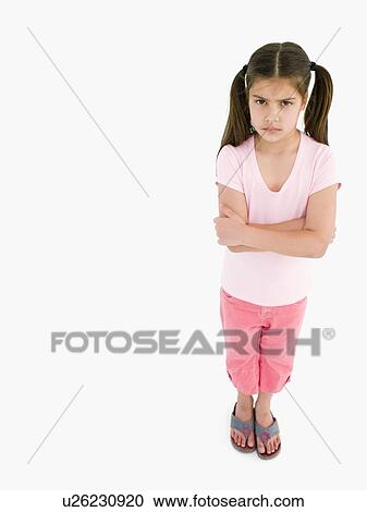 Stock Image - Young girl with arms crossed angry. Fotosearch