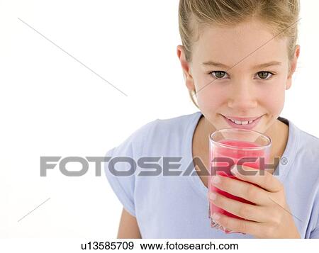 Young girl with glass of juice smiling View Large Photo Image Stock Photo - Young girl with glass of juice smiling. Fotosearch