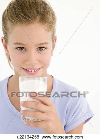 Stock Photo - Young girl with glass of milk smiling. Fotosearch