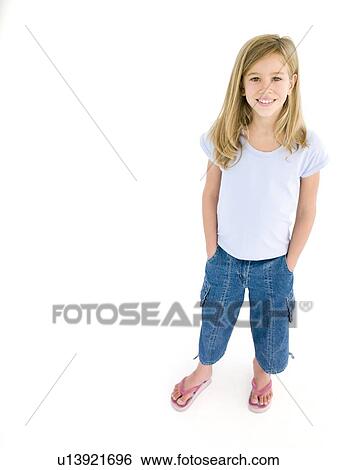Young girl with hands in pockets smiling View Large Photo Image Stock Photograph - Young girl with hands in pockets smiling. Fotosearch