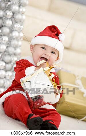 Baby In Santa Costume At Christmas View Large Photo Image Stock Photograph - Baby In Santa Costume At Christmas. Fotosearch