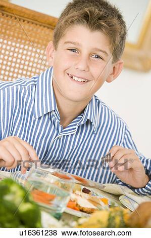 Stock Photo - Boy At Christmas Dinner. Fotosearch