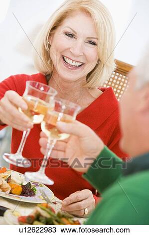 Couple Toasting At Christmas Dinner View Large Photo Image Stock Image - Couple Toasting At Christmas Dinner. Fotosearch