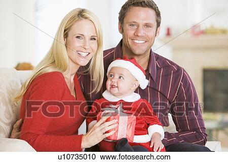 Couple With Baby In Santa Outfit View Large Photo Image Stock Image - Couple With Baby In Santa Outfit. Fotosearch