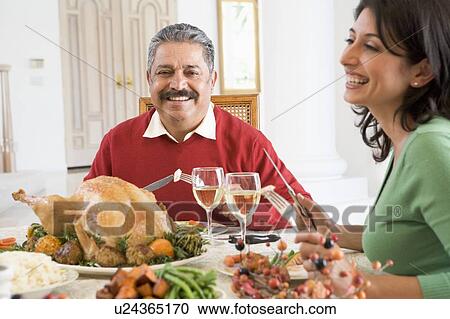 Father And His Adult Daughter Sitting Down For Christmas Dinner View Large Photo Image Stock Image - Father And His Adult Daughter Sitting Down For Christmas Dinner. Fotosearch