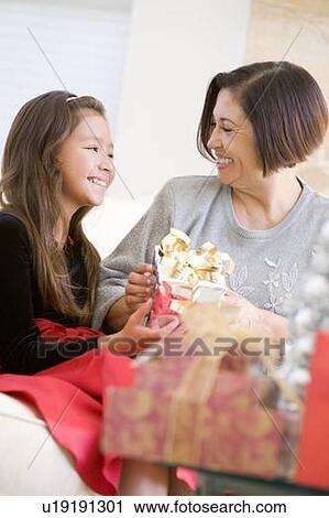 Grandmother And Granddaughter Exchanging Christmas Gifts View Large Photo Image Stock Image - Grandmother And Granddaughter Exchanging Christmas Gifts. Fotosearch