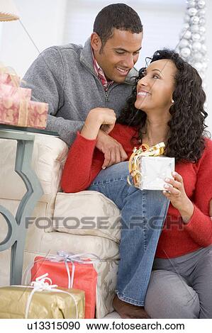 Husband And Wife Affectionately Exchanging Christmas Gifts View Large Photo Image Stock Image - Husband And Wife Affectionately Exchanging Christmas Gifts. Fotosearch