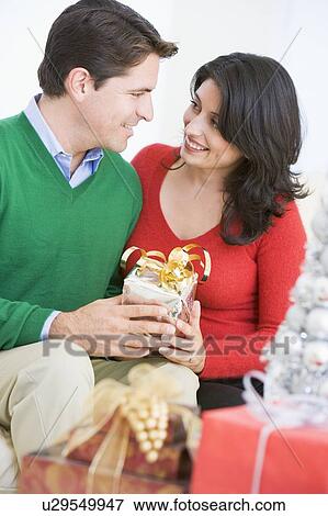 Husband Surprising Wife With Christmas Present View Large Photo Image Stock Photo - Husband Surprising Wife With Christmas Present. Fotosearch