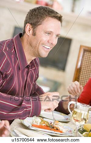 Picture - Man Enjoying Christmas Dinner. Fotosearch