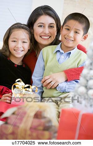 Mother With Her Daughter And Son Holding Christmas Gifts View Large Photo Image Stock Photography - Mother With Her Daughter And Son Holding Christmas Gifts. Fotosearch