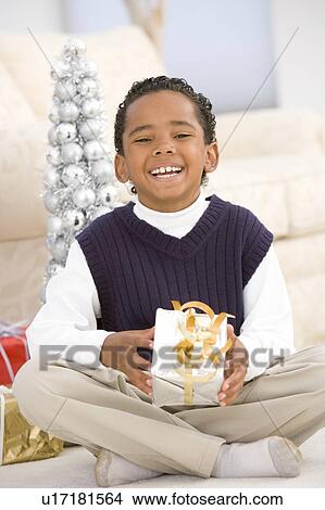 Picture - Portrait Of Boy With Christmas Present. Fotosearch