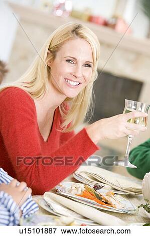 Stock Photo - Woman Enjoying Christmas Dinner. Fotosearch