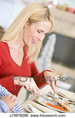 Stock Photograph - Woman Enjoying Christmas Dinner. Fotosearch