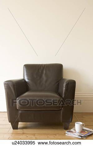 Stock Photography - Chair with coffee mug and magazine beside it. Fotosearch