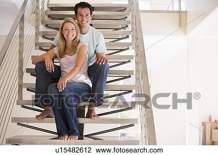 Couple sitting on staircase smiling View Large Photo Image Stock Image - Couple sitting on staircase smiling. Fotosearch