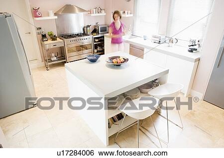 Woman in kitchen preparing food View Large Photo Image Stock Photograph - Woman in kitchen preparing food. Fotosearch