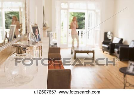 Woman in living room talking on telephone View Large Photo Image Stock Photo - Woman in living room talking on telephone. Fotosearch