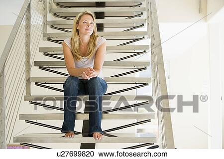 Woman sitting on stairs View Large Photo Image Stock Image - Woman sitting on stairs. Fotosearch