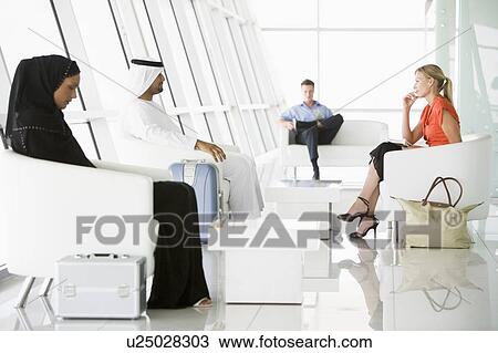 Stock Image - Airline passengers waiting in departure gate. Fotosearch