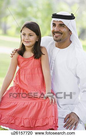 Man and young girl outdoors in a park smiling (selective focus) View Large Photo Image Stock Image - Man and young girl outdoors in a park smiling (selective focus). Fotosearch
