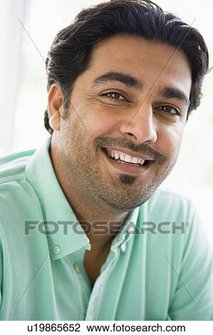 Man indoors smiling (high key) View Large Photo Image Stock Image - Man indoors smiling (high key). Fotosearch