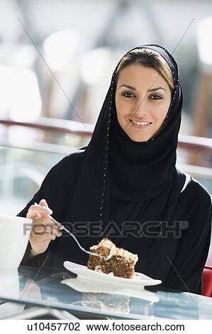 Woman at restaurant eating dessert and smiling (selective focus) View Large Photo Image Stock Image - Woman at restaurant eating dessert and smiling (selective focus). Fotosearch