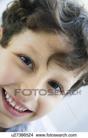 Picture - Young boy indoors smiling (high key). Fotosearch