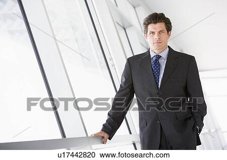 Businessman standing in corridor View Large Photo Image Stock Image - Businessman standing in corridor. Fotosearch