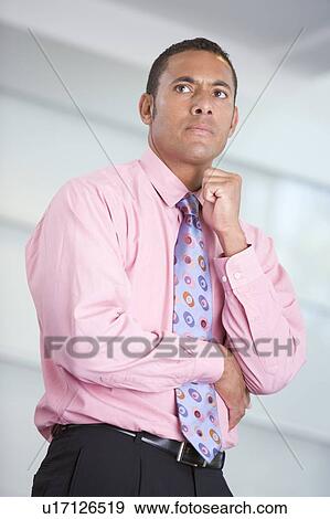 Stock Photo - Businessman standing indoors. Fotosearch