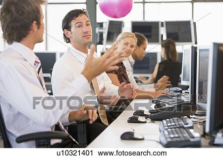 Five businesspeople in office space with a ball being thrown View Large Photo Image Stock Image - Five businesspeople in office space with a ball being thrown. Fotosearch