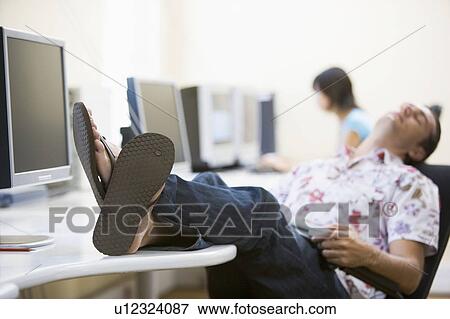 Man in computer room sleeping View Large Photo Image Stock Photo - Man in computer room sleeping. Fotosearch