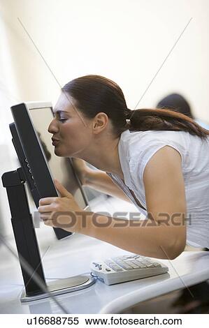 Woman in computer room kissing monitor View Large Photo Image Stock Photography - Woman in computer room kissing monitor. Fotosearch